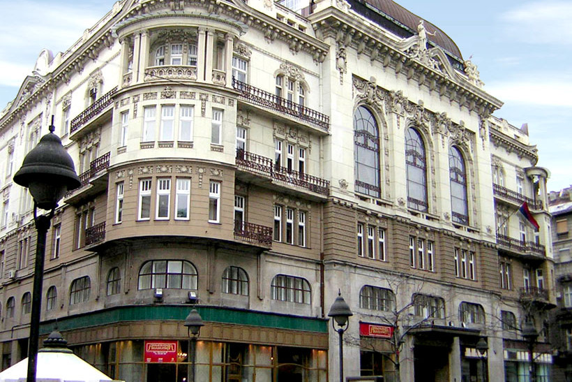 Ornate corner facade of the Academy of Sciences and Arts in Belgrade with arched windows and balconies
