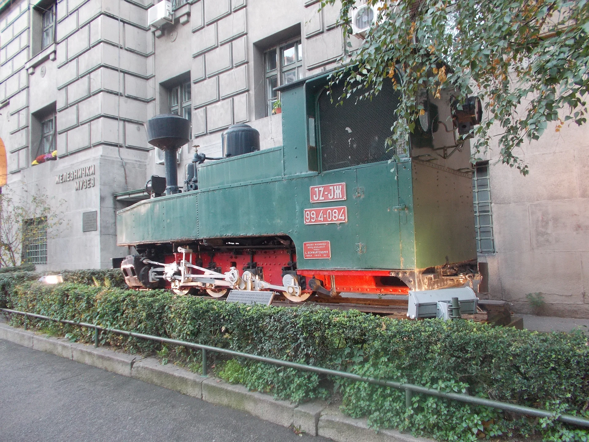 Preserved green locomotive displayed outside the Railway Museum at Old Main Station in Belgrade