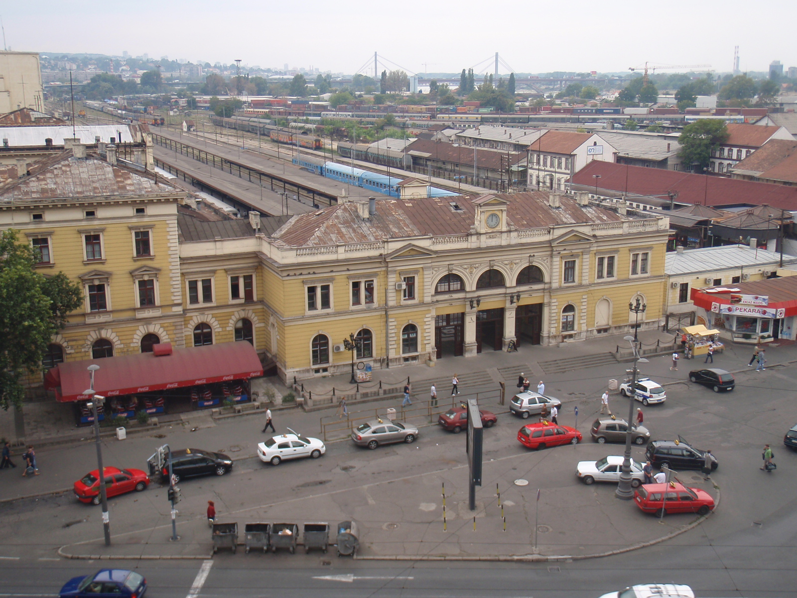 Old Main Station in Belgrade beside rail platforms, traffic, and nearby city buildings