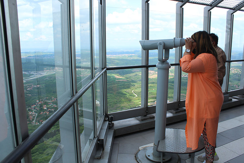 Interior of the Avala Tower observation deck with windows facing Belgrade