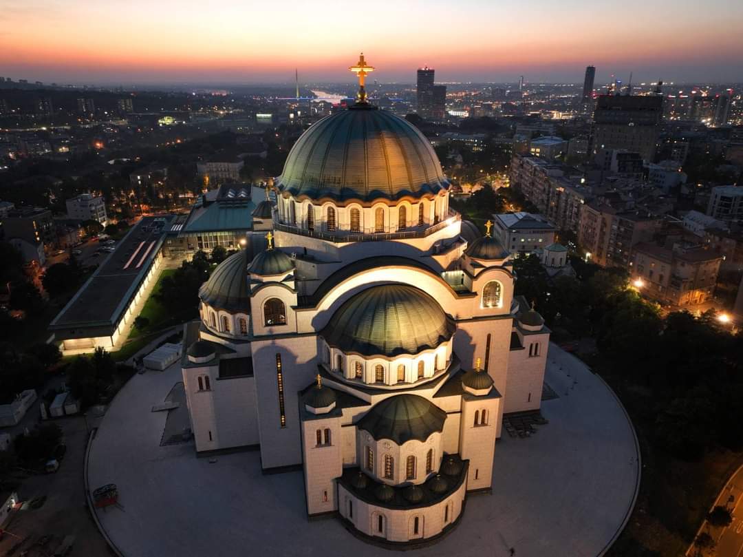 Temple of Saint Sava illuminated at dusk above the Belgrade skyline
