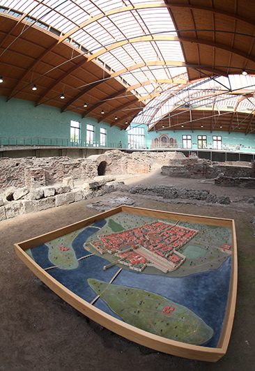 Ruins and a scale model beneath the covered hall at the Imperial Palace of Sirmium