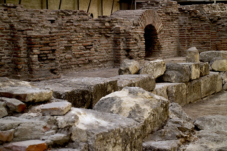 Brick and stone ruins with an arched opening at the Imperial Palace of Sirmium