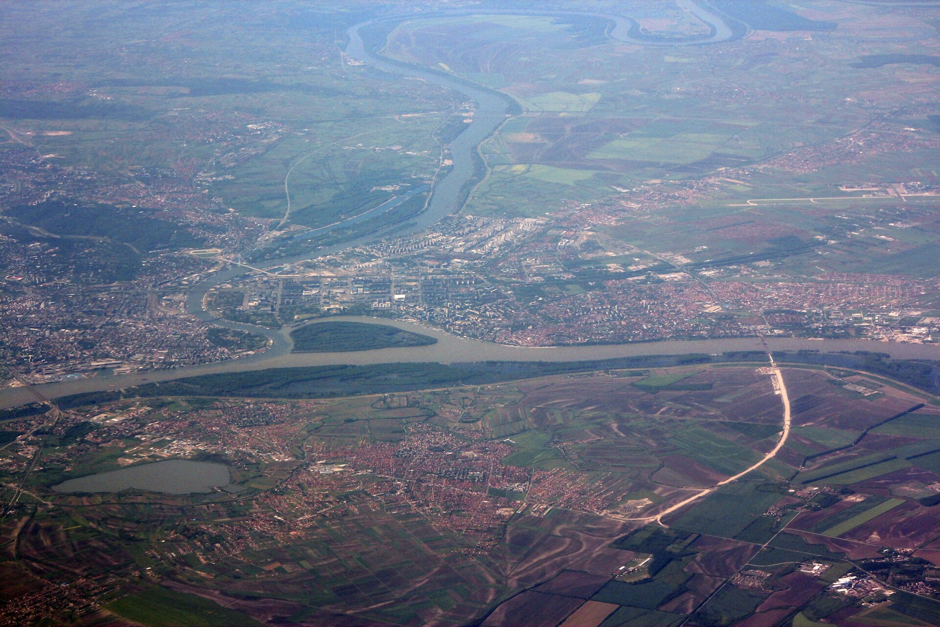 Aerial view of the Danube river bend, settlements, and fields around Zemun