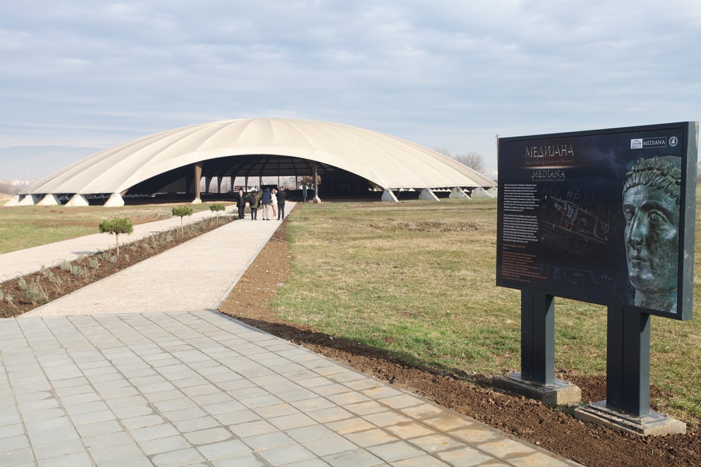 Domed pavilion and walkway at the Mediana archaeological site in Niš, with an information board nearby