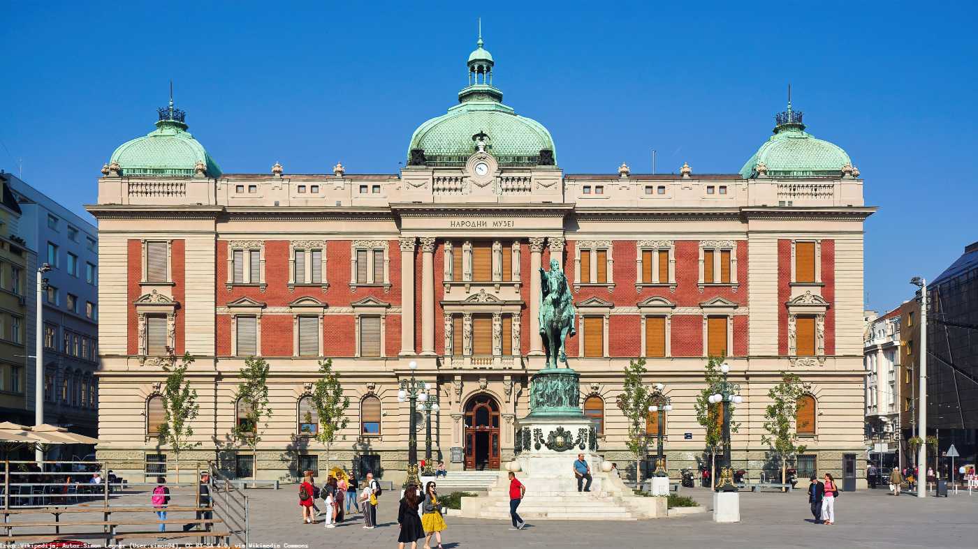National Museum in Belgrade facade with green domes and a statue in the square