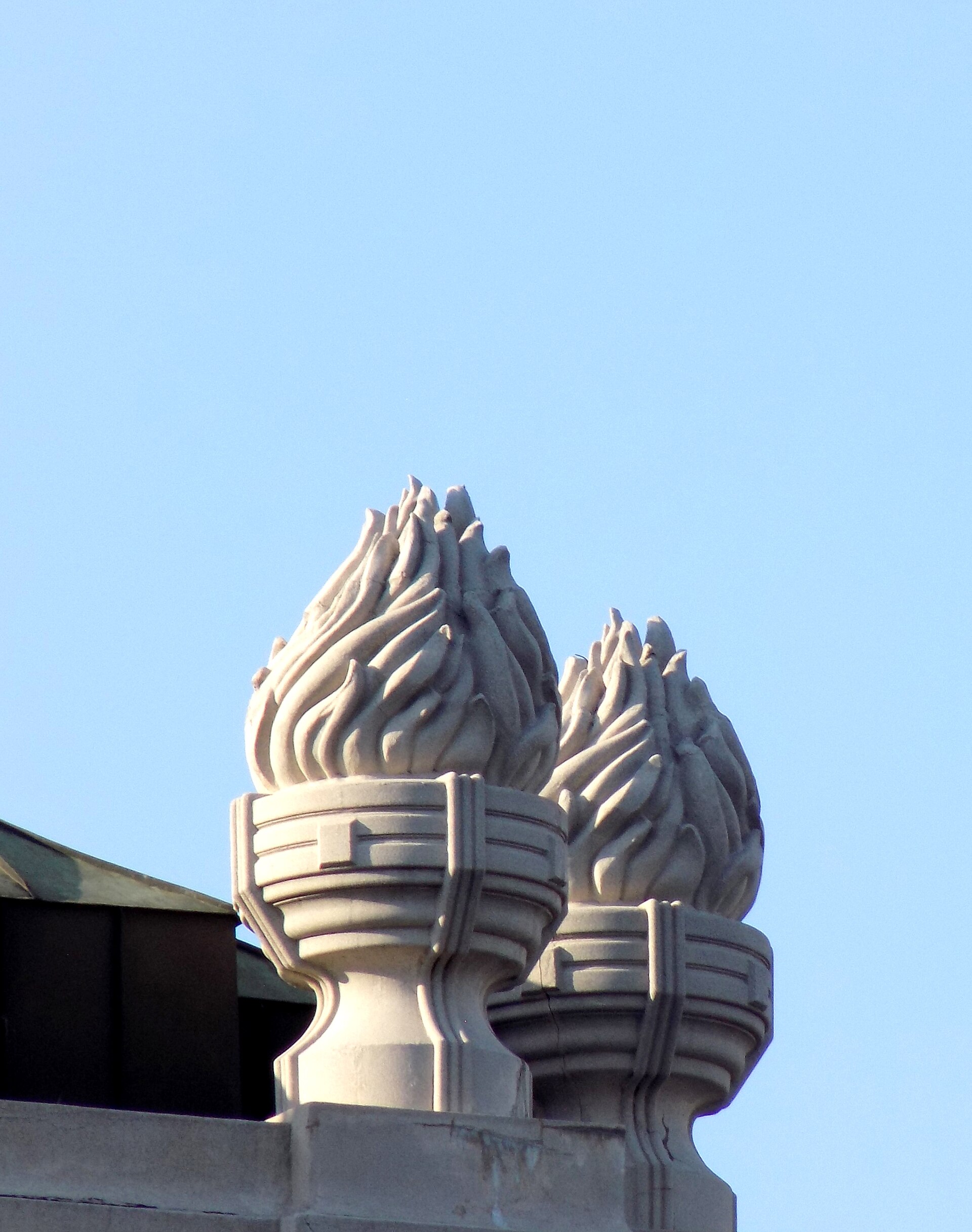 Decorative rooftop finials on the National Theatre in Belgrade against a clear blue sky