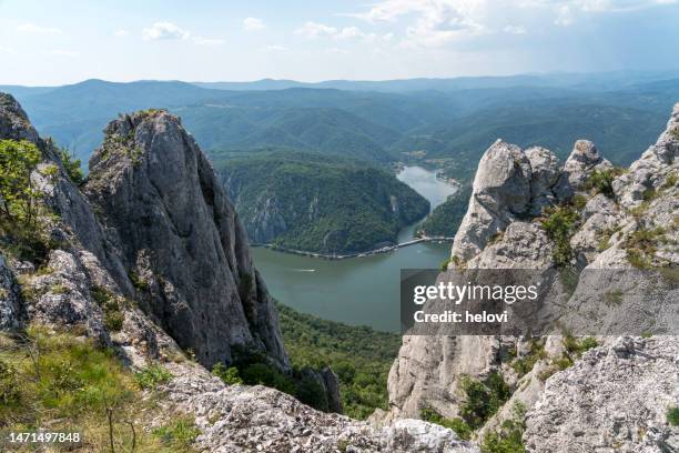 Steep limestone cliffs framing a winding Danube River bend in Serbia