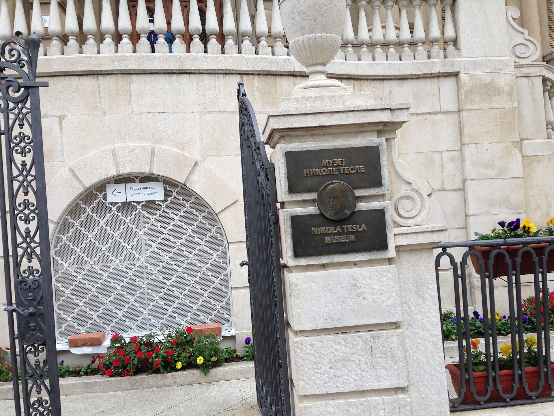 Ornate entrance gate and sign at Nikola Tesla Museum in Belgrade