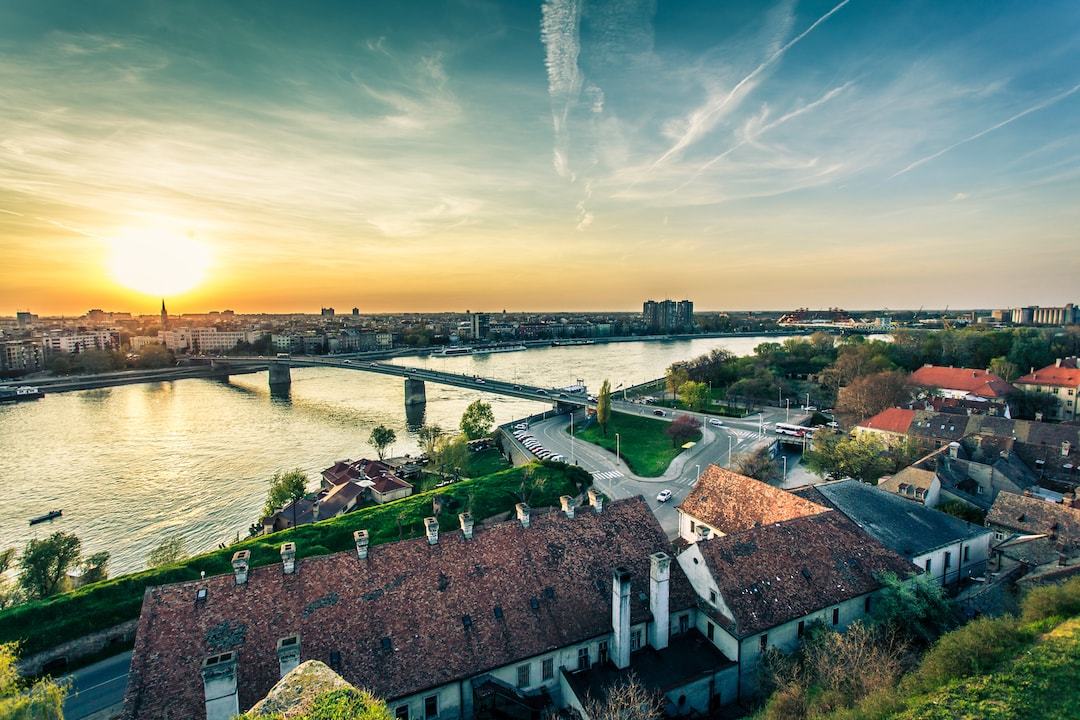 Sunset over a river bridge, rooftops, and roads in Novi Beograd
