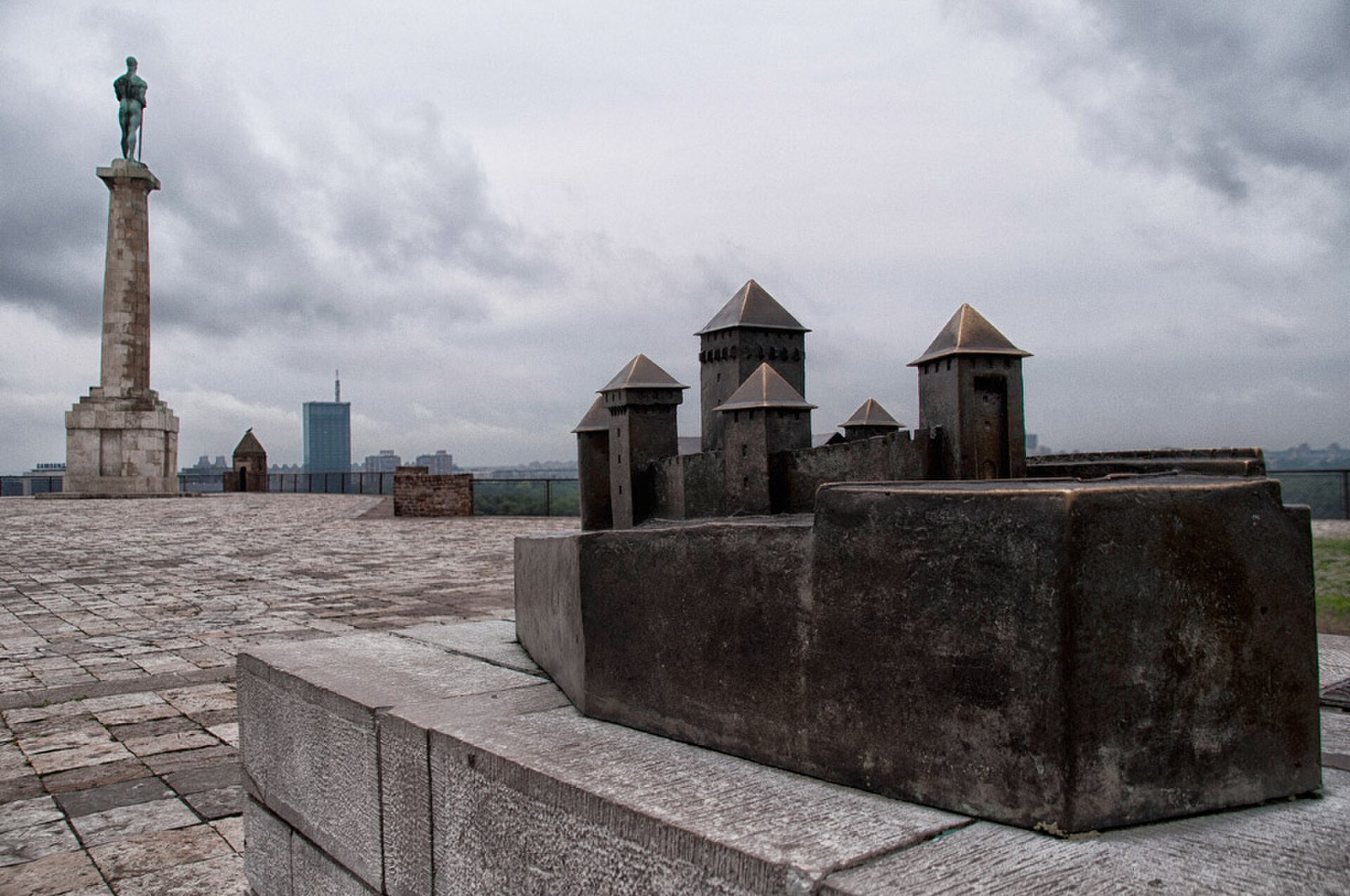Pobednik Monument beside a fortress model at the Belgrade location under a cloudy sky