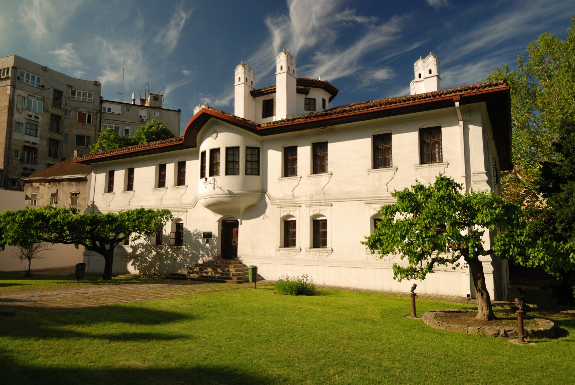 White historic residence with tiled roof and courtyard trees at the Residence of Princess Ljubica in Belgrade