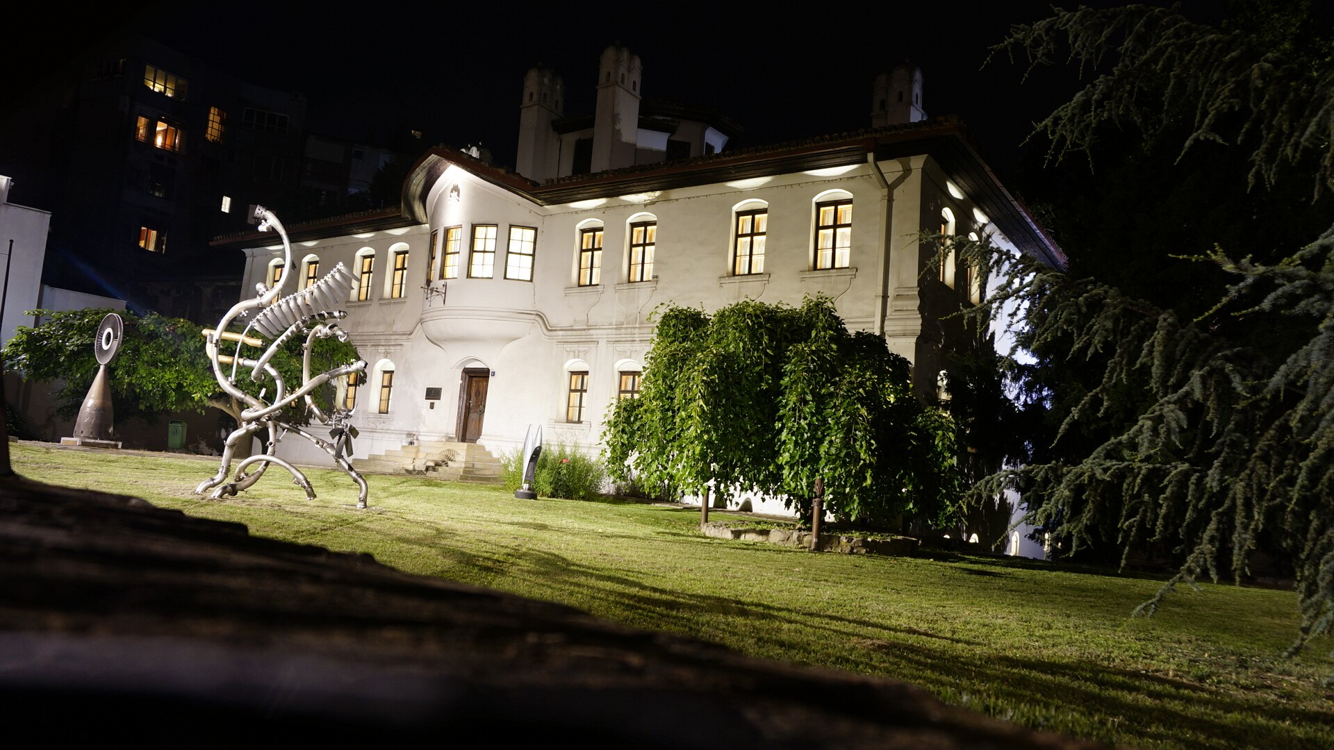 Illuminated Residence of Princess Ljubica with lawn and sculpture at night in Belgrade