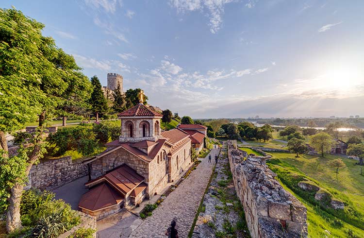Stone church beside a fortress wall and path overlooking the landscape at Kalemegdan in Belgrade