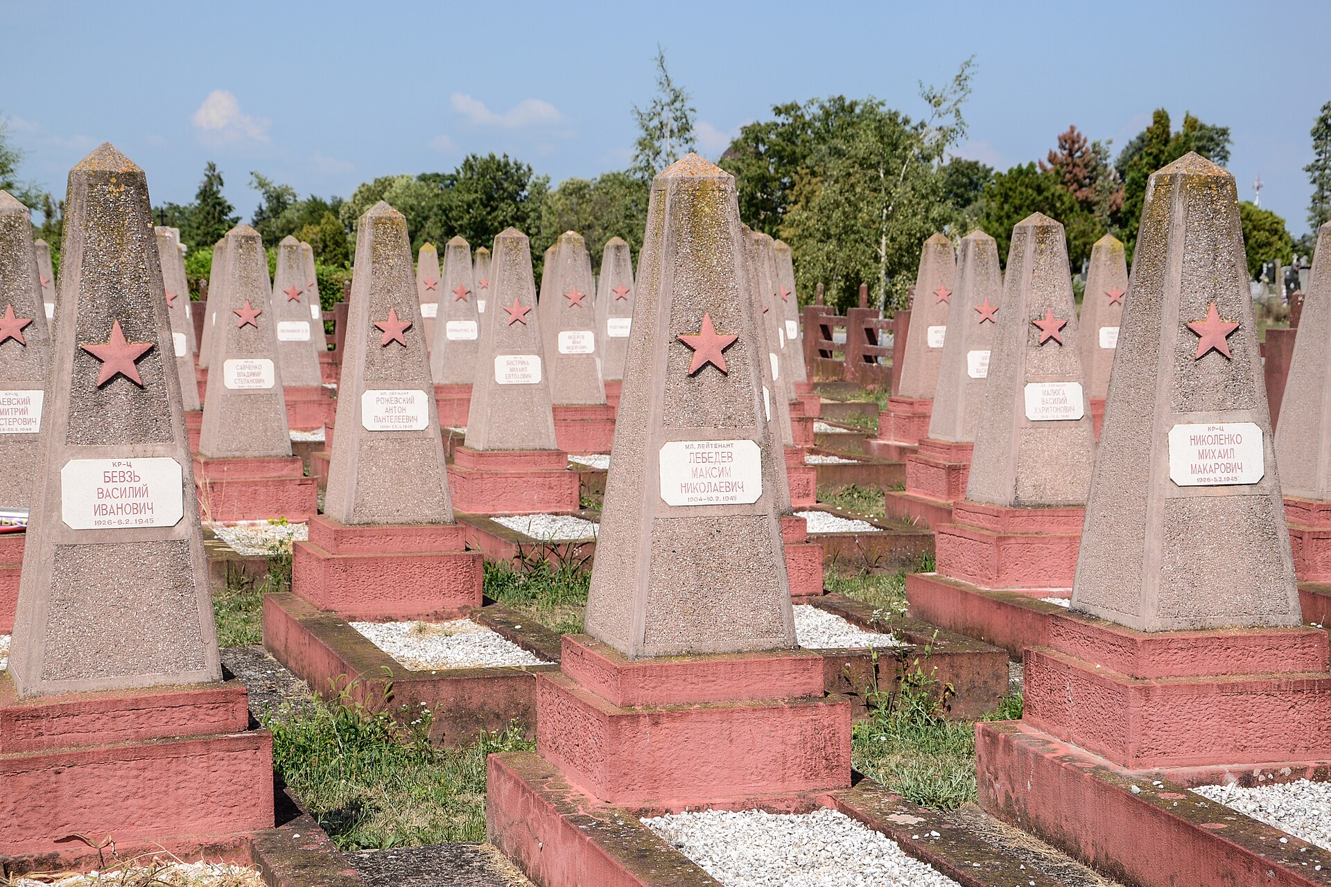 Rows of Soviet-style gravestones with red stars in a cemetery in Sombor