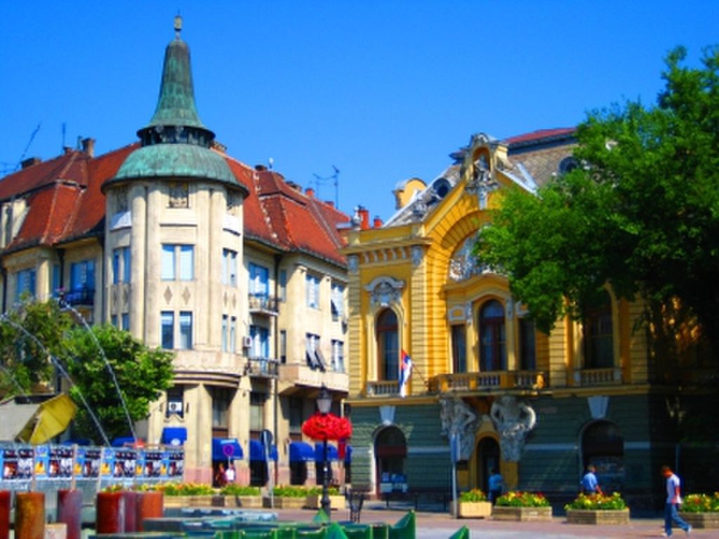 Art Nouveau buildings with a turret and yellow facade in central Subotica