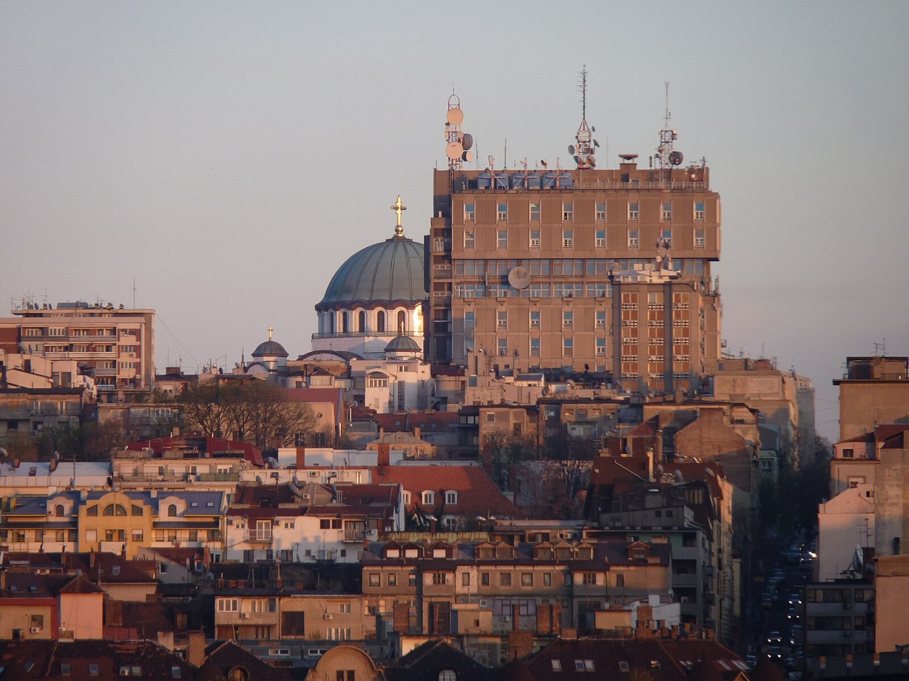 Saint Sava Temple dome above dense Vračar rooftops and surrounding office buildings