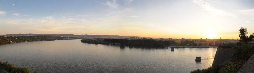 Sunset panorama over the Danube and Novi Sad from Petrovaradin Fortress with bridges and distant hills