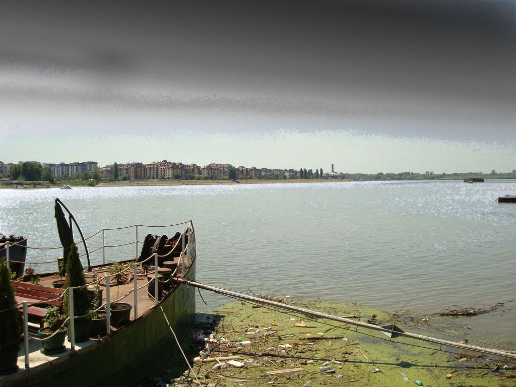 Terrace boat on the Sava River with Belgrade apartments across the water